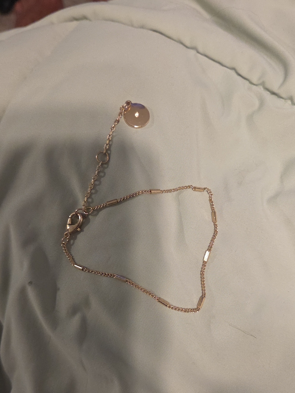 3 gold bracelets.